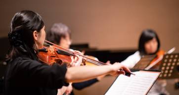 Musician playing violin at classical concert