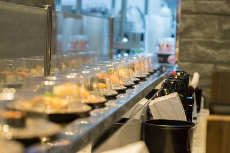 row of revolving sushi dishes