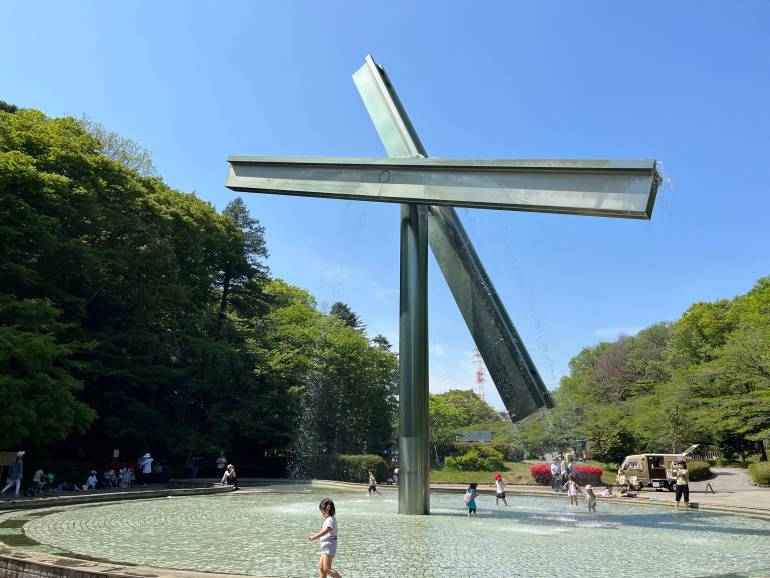 Water fountain sculpture and children playing