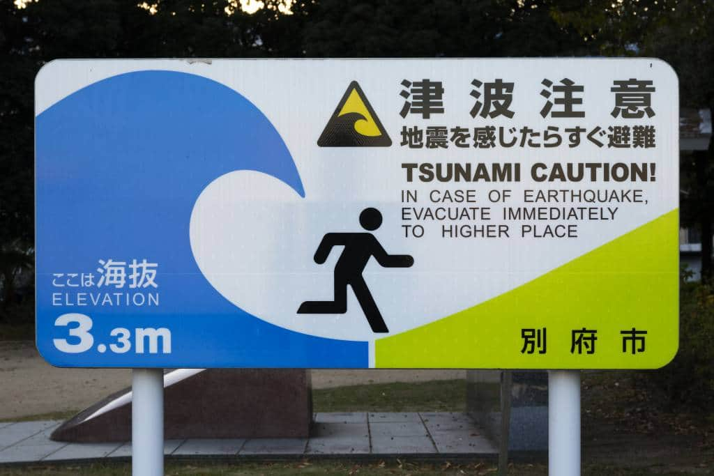 Beppu, Japan - November 1, 2018: National sign with Tsunami Caution placed in every city near the coast at Kyushu, Japan