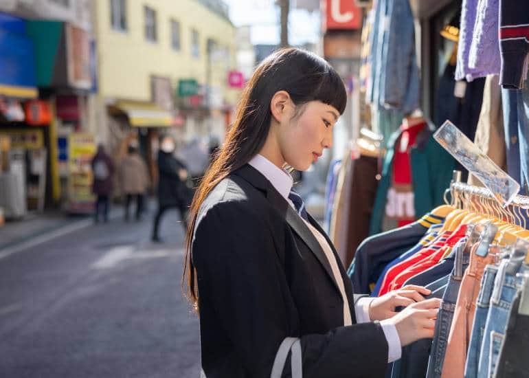 Woman shopping at clothing store, on street in Tokyo