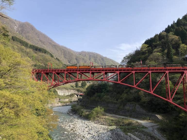 Kurobe Gorge Railway train crossing bridge