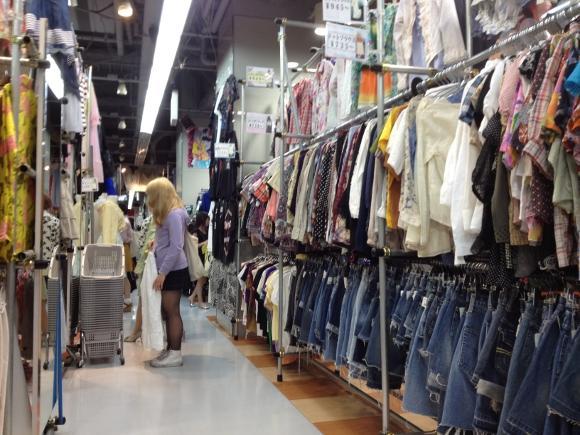 A customer browses through clothes at Kinji