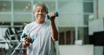 japanese older man with dumbells