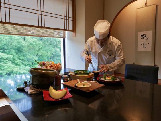 chef arranges course meal in tatami room