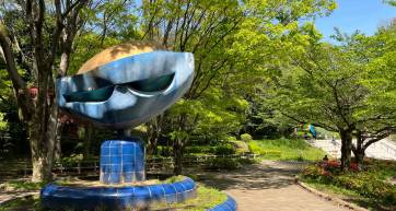 Blue sculpture and trees