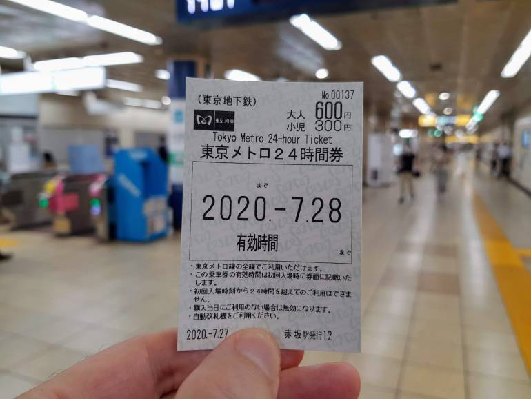 A 24 hour Tokyo Metro ticket held up inside a Tokyo Metro Station